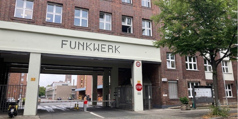 Brick building, "Funkwerk" is written above the large gateway
