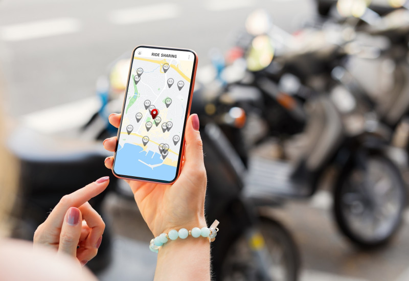 A woman rents a scooter via an app