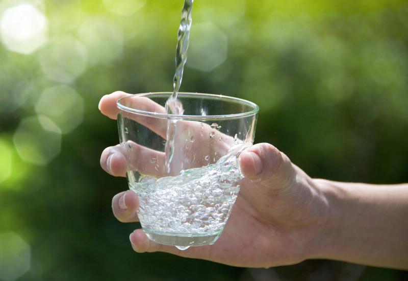 clear water is poured in a glass